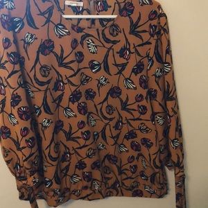 Mustard-color floral blouse, with flowers.